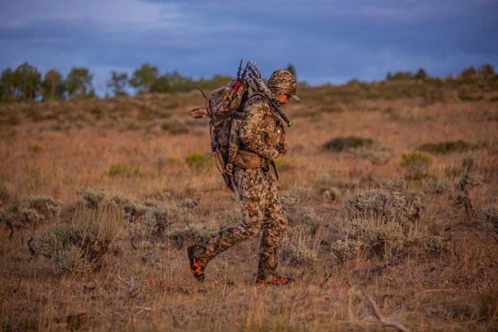 hunter walking through a barren desert field