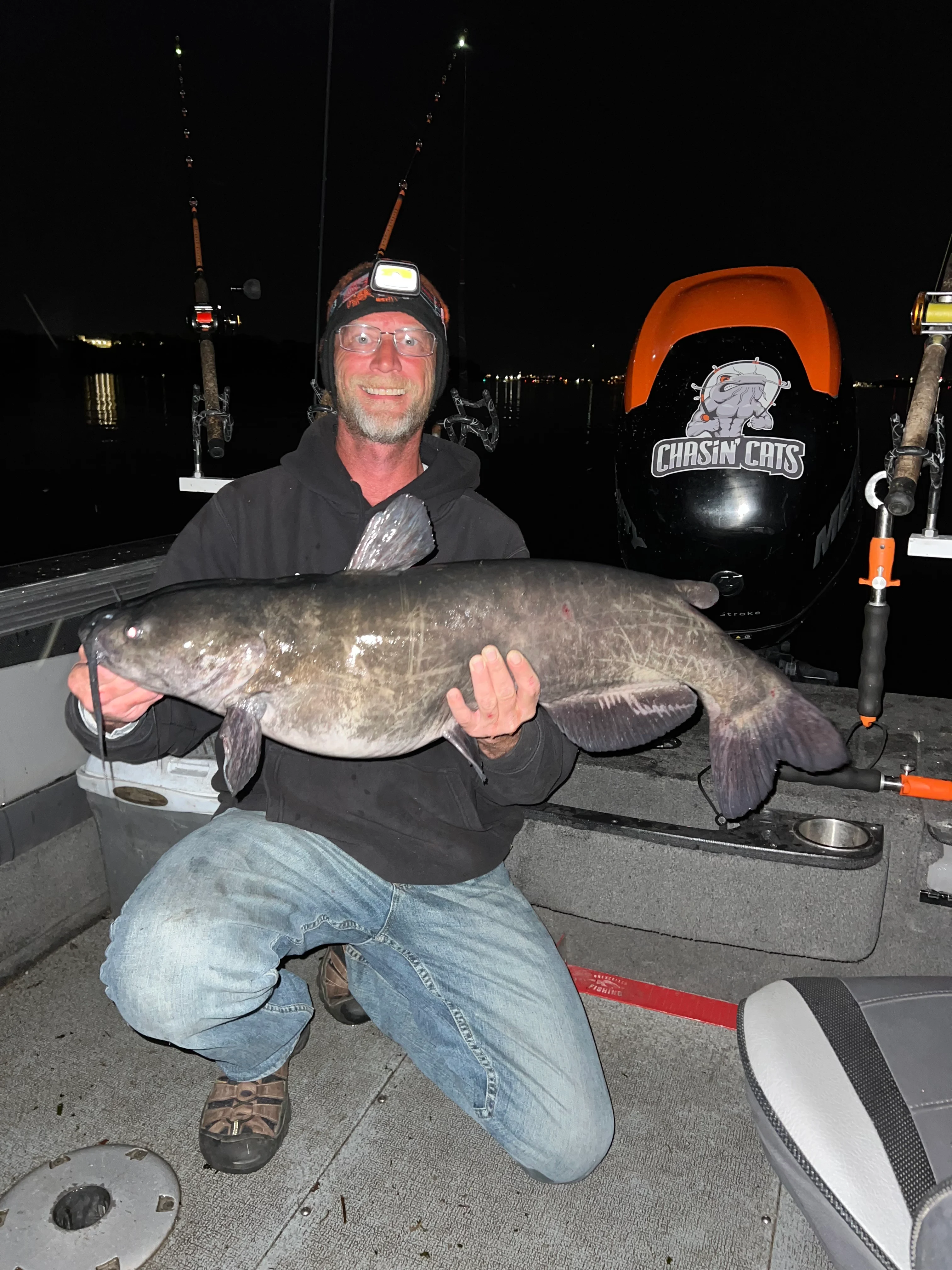 Angler holding up catfish on boat