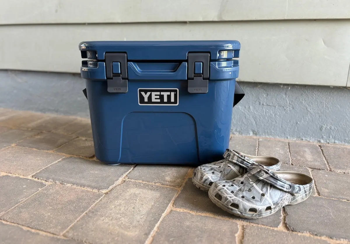 Navy Yeti Roadie 15 hard cooler sitting on ground