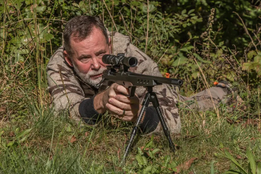 Man shooting a handgun from the ground.