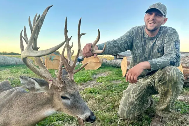 A bow hunter poses with a trophy deer taken on public land in Illinois. 