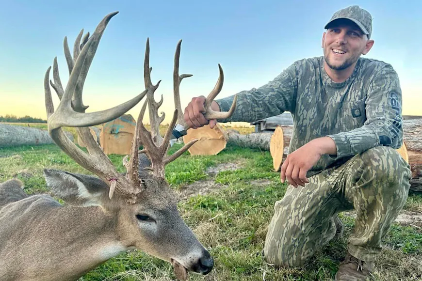 A bow hunter poses with a trophy deer taken on public land in Illinois.