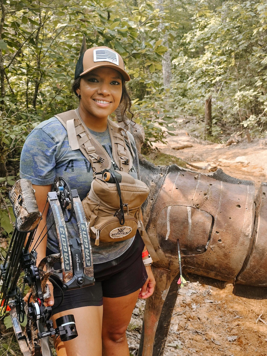 Female hunter holding the Bowtech Eva Gen3 Compound bow at the Bowtech Rally