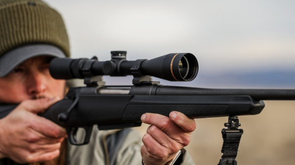 Hunter shooting rifle with Leupold Rifle Scope