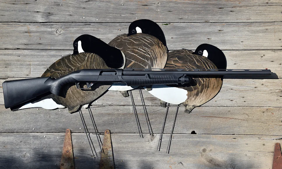 The new Benelli Nova 3 shotgun on barn board with three goose decoys.