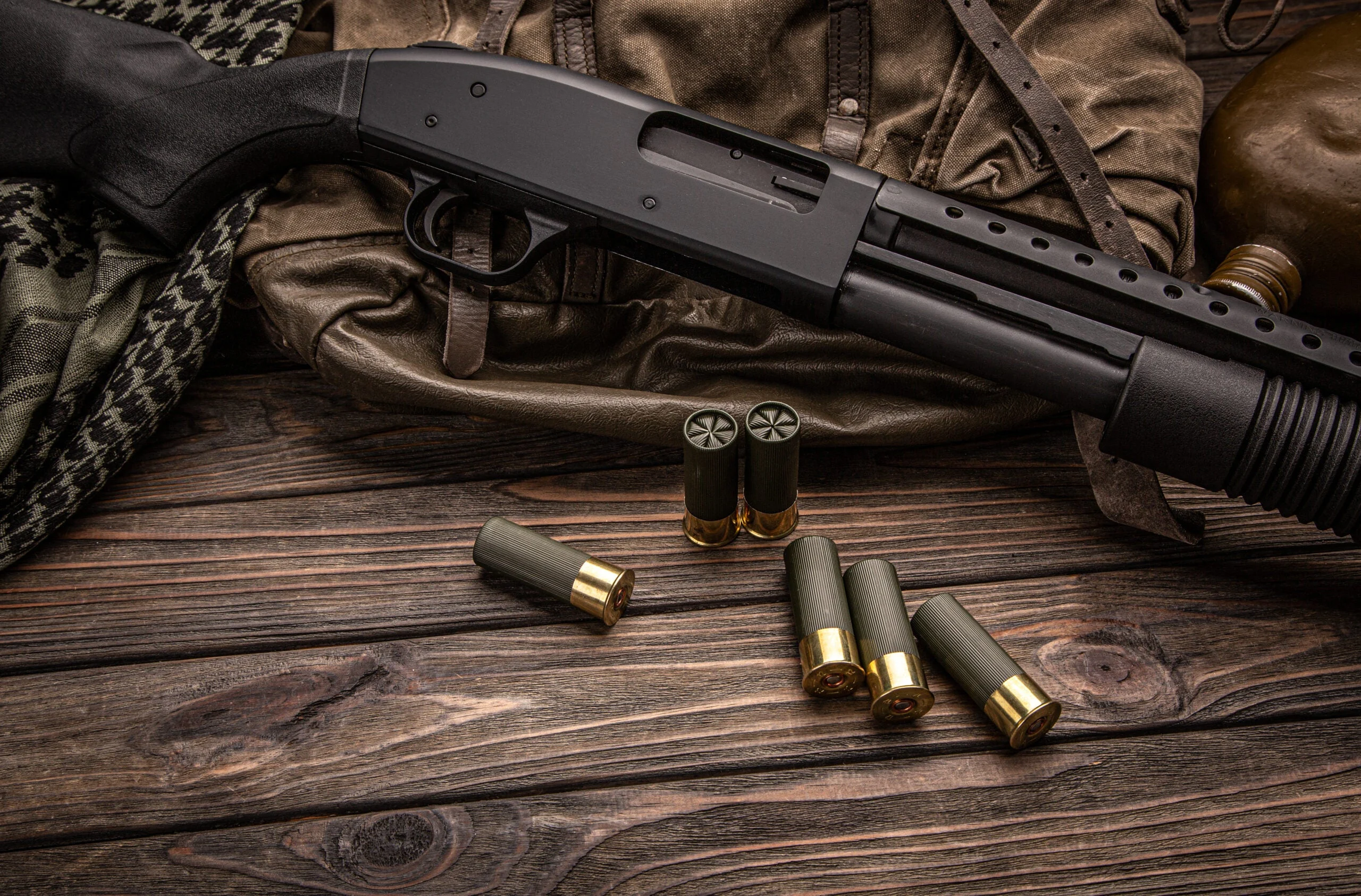 Photo of a home defense shotgun and buckshot shells