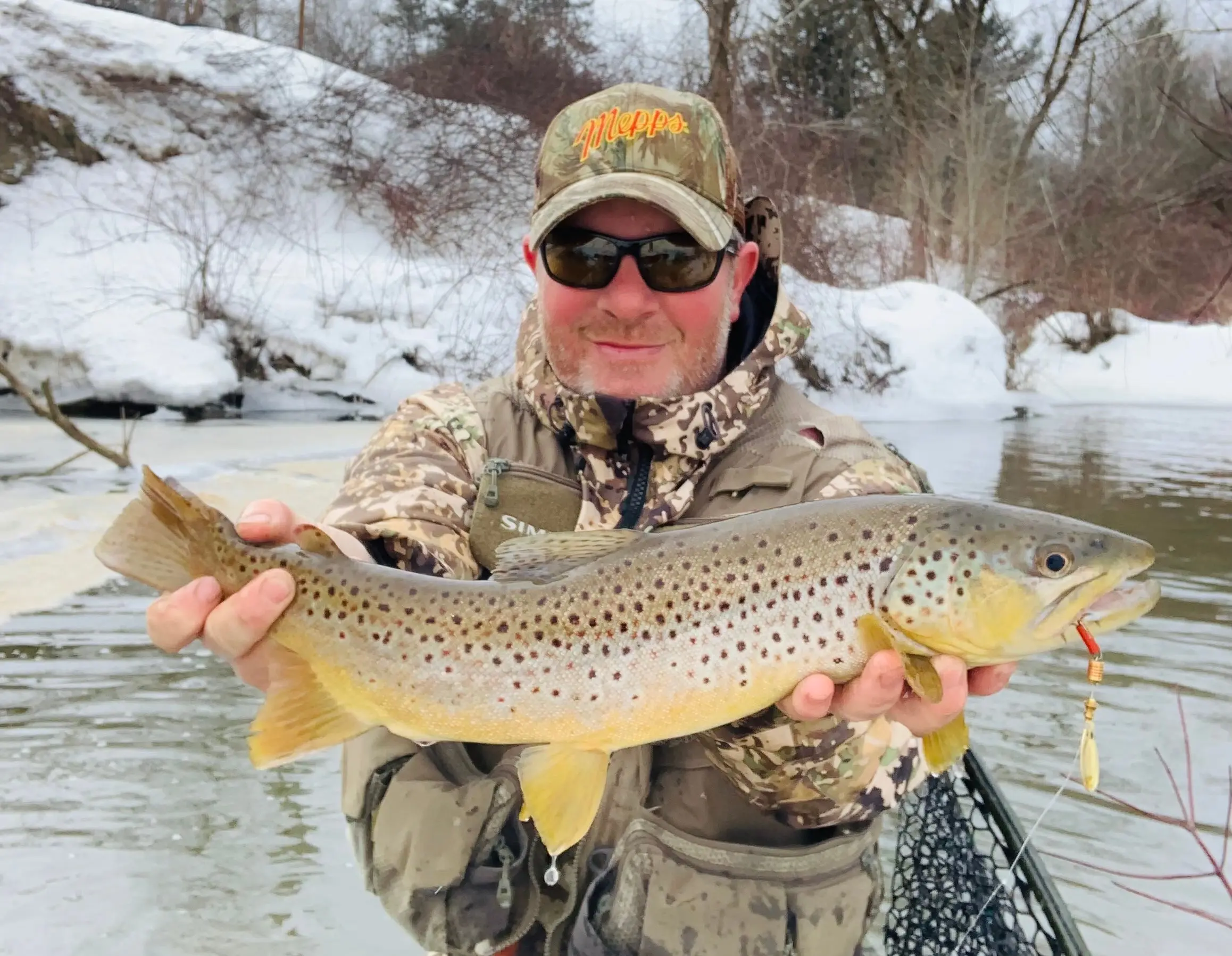 photo of angler with big brown trout