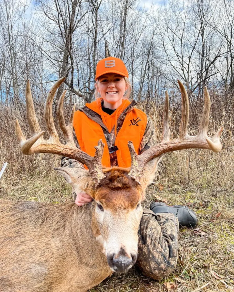 woman poses with huge whitetail buck