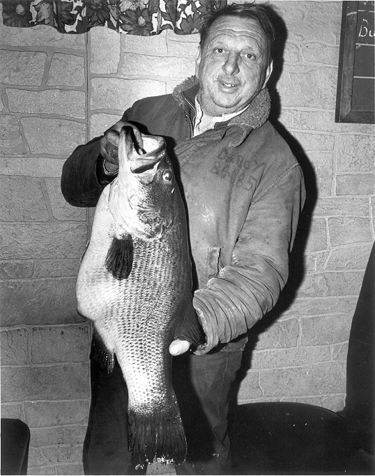 An angler poses with the Massachusetts state record largemouth bass. 