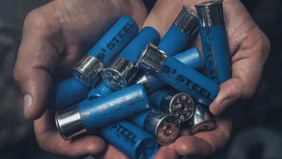 shotgun shells in a person's hands