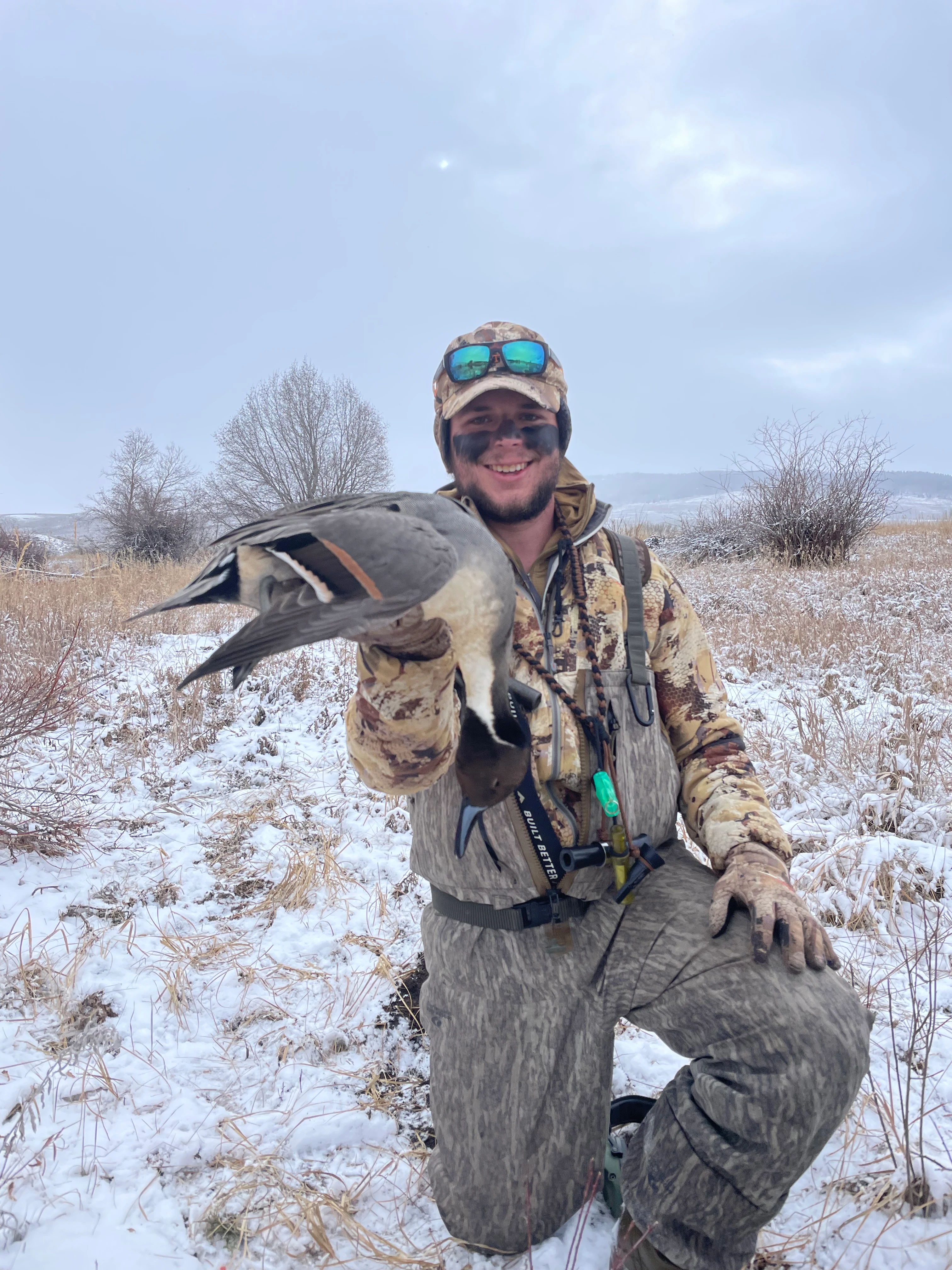 Hunter holding a drake pintail 