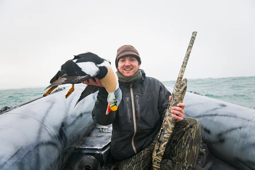 Ryan Chelius holds up King Eider