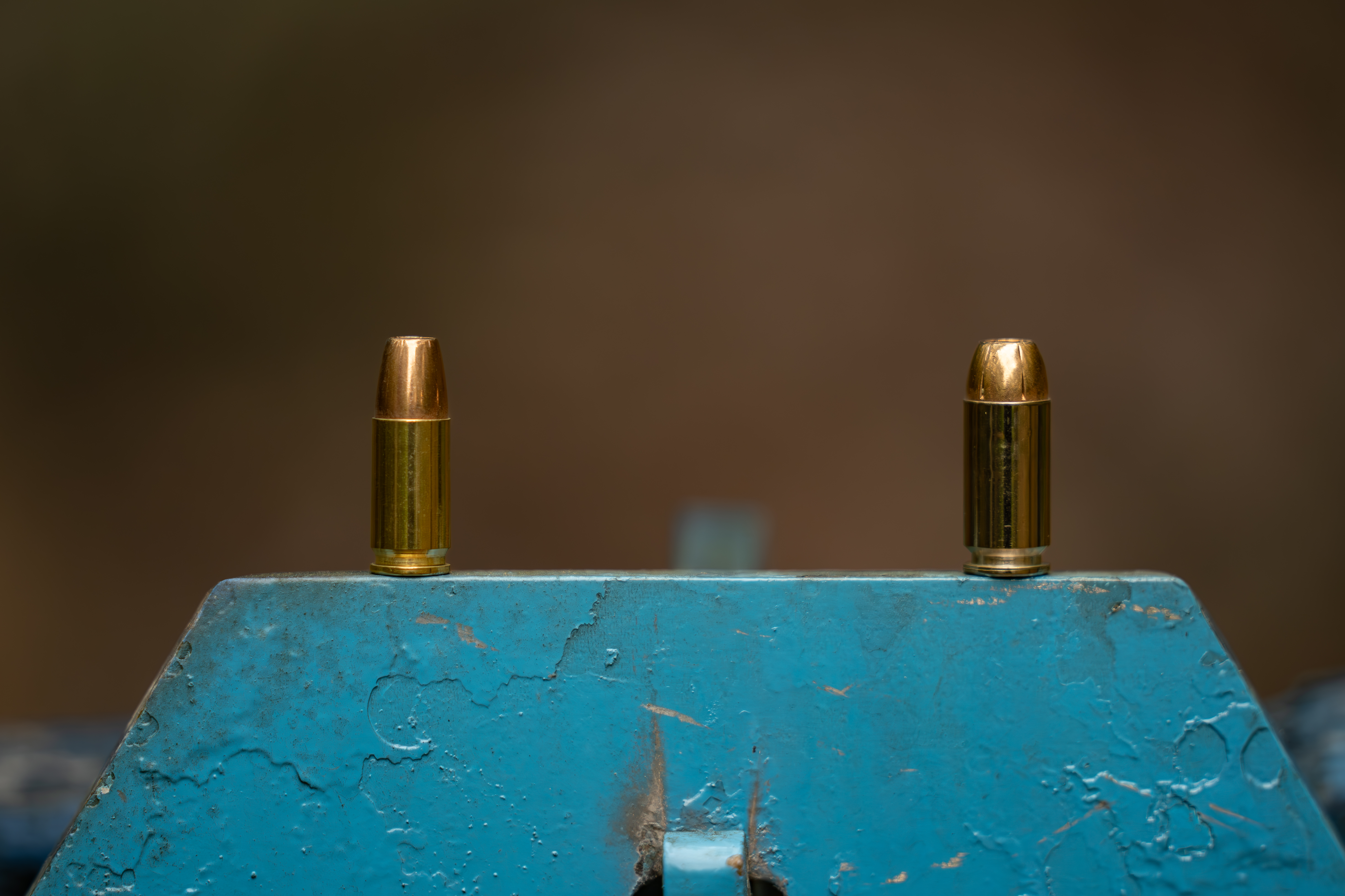 9mm cartridge left and 40 S&W cartridge right on white background.