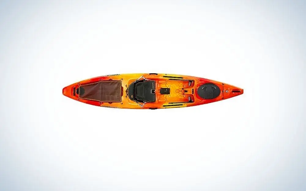 A kayak in an orange in the body and black on the place where you can sit.