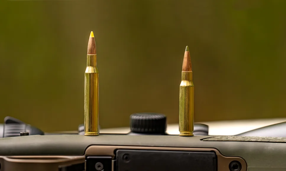 A 270 round and 308 round standing up on a rifle to illustrate 270 vs 308.