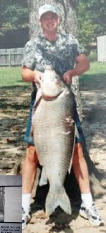 A bowfisherman poses with a world record bigmouth buffalo.