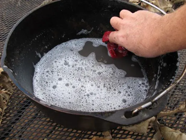 Clean off loose bits of old seasoning, burned-on food scraps, and other build up.