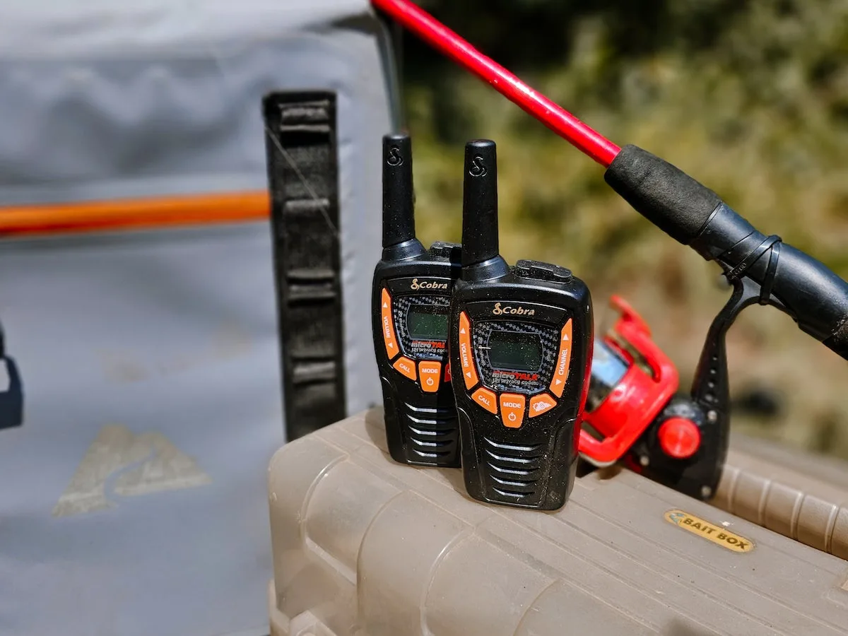 Cobra ACTX345 Walkie Talkies sitting on tackle box