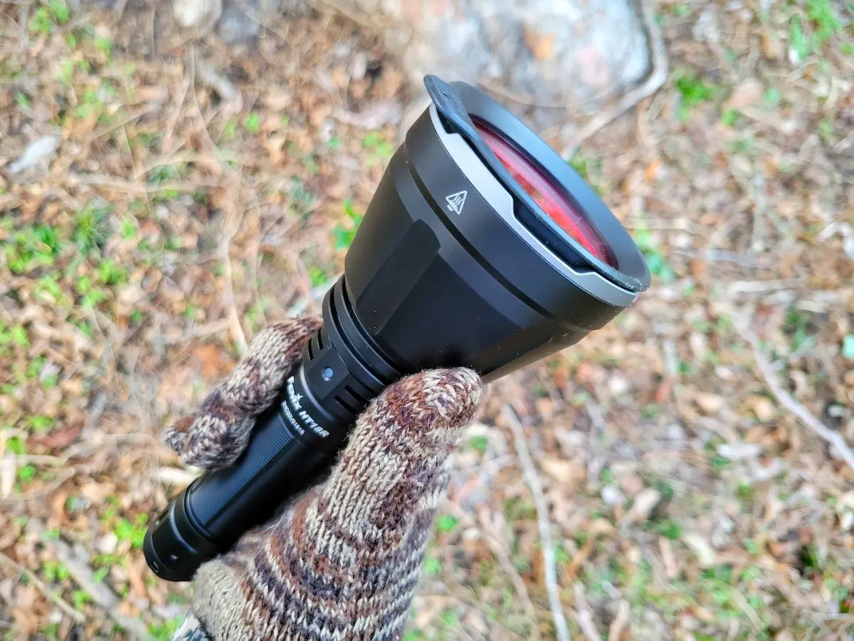 Close-up of hand holding Fenix HT18R Long-Distance Flashlight