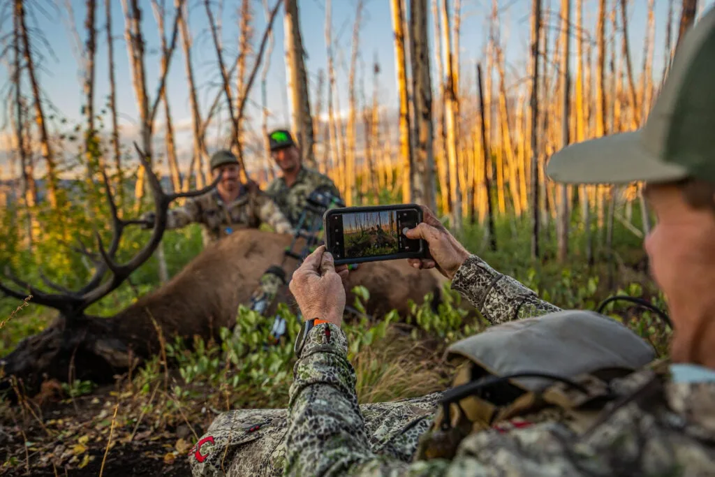 Jace Bauserman takes picture of bull elk.