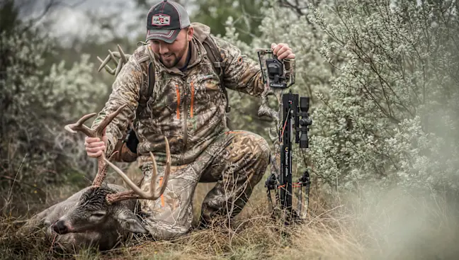 Photo of hunter with whitetail deer; inset of illustration field-dressing instructions