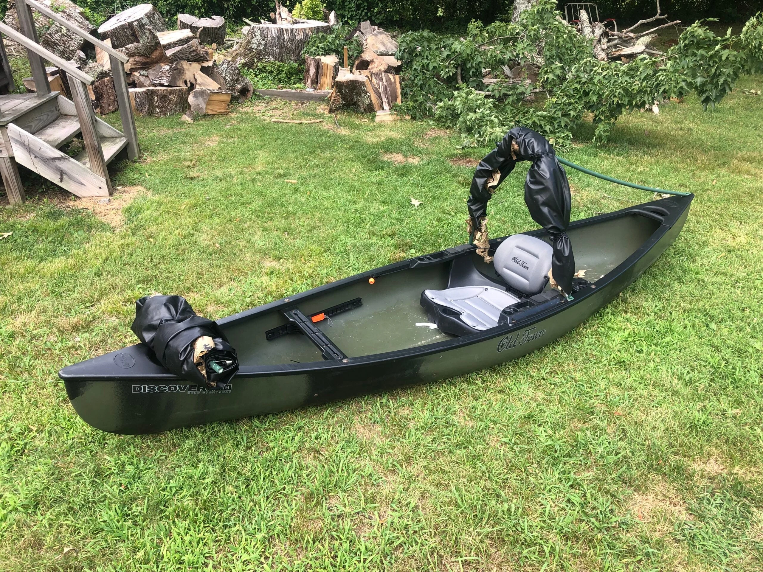 Old Town 119 Solo Sportsman canoe lying on a green lawn