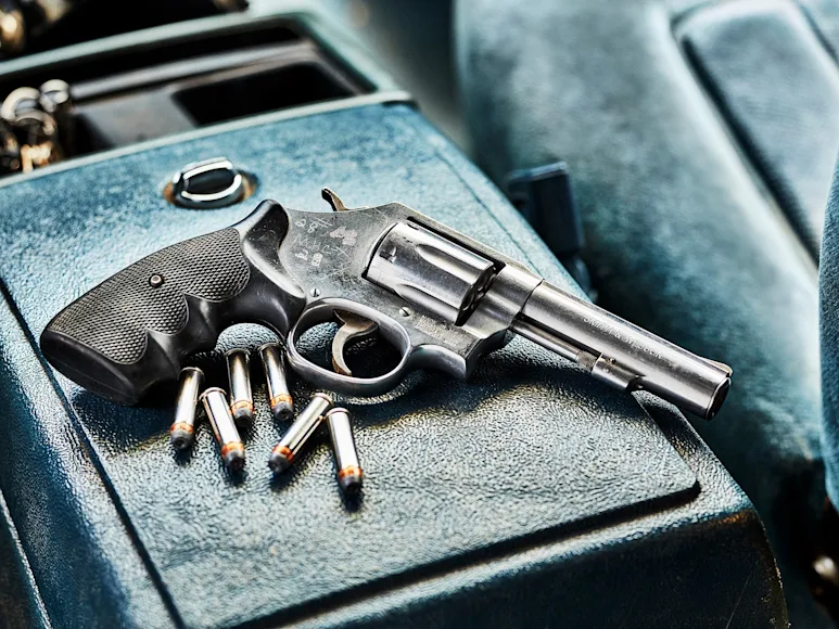 Revolver on the center console of a truck.