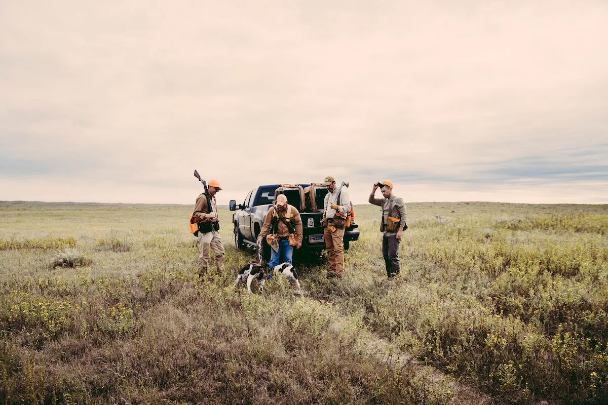 Hunters gathered around pickup truck trailgate