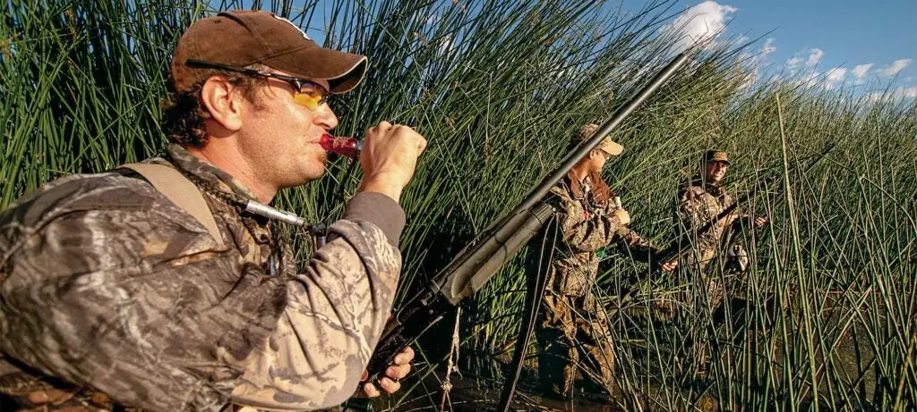 teal hunters calling in marsh