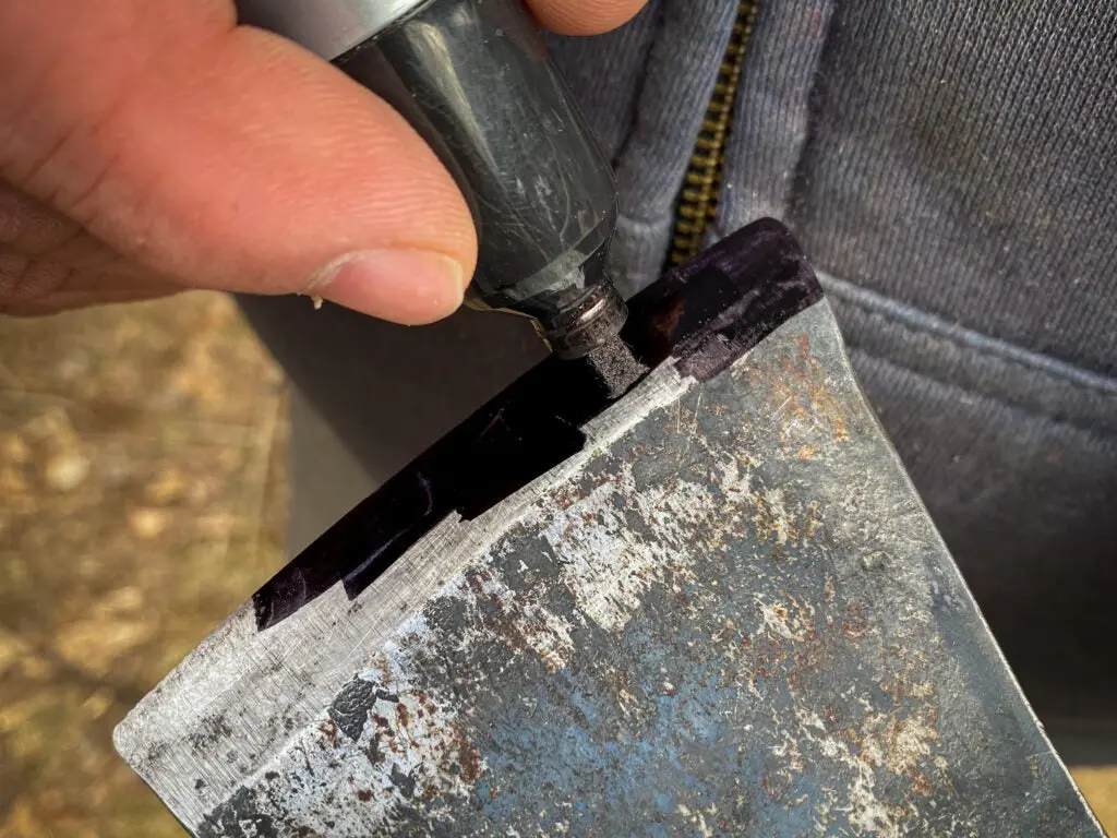 Using a permanent marker to mark an axe's beveled edge