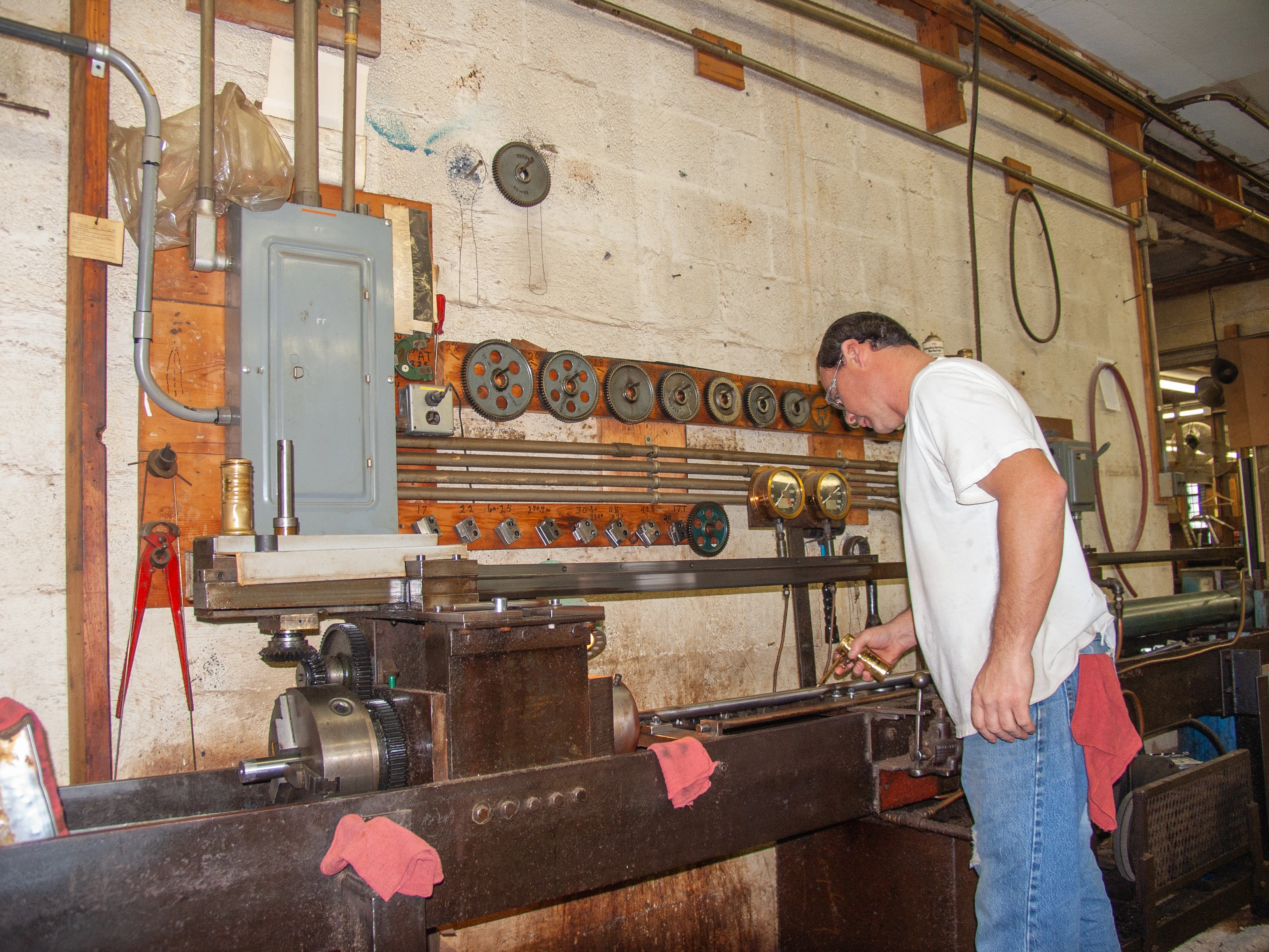 A barrel-maker at Douglas Barrels rifles a barrel in a workshop. 