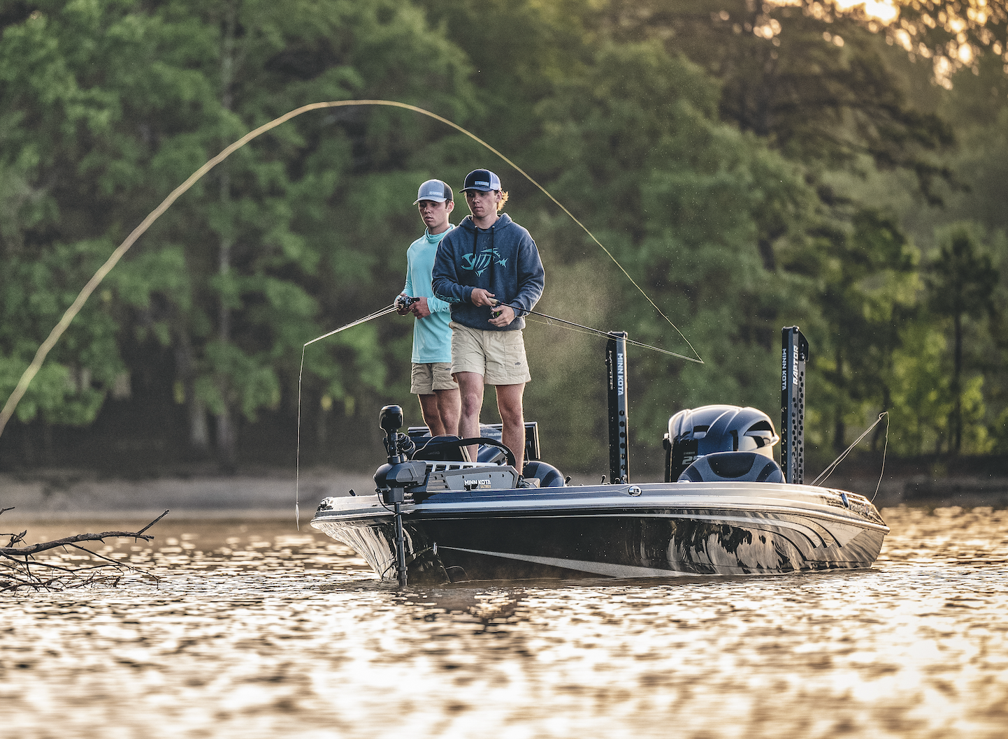 A pair of bass anglers cast to a shoreline.