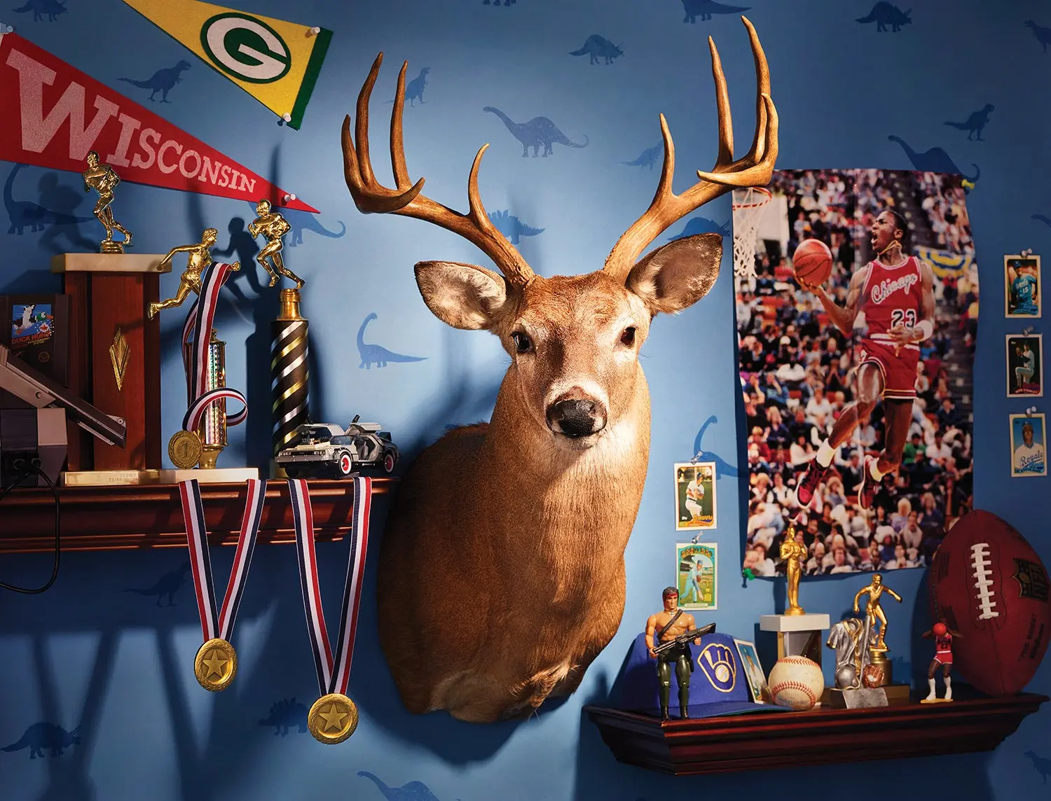 kid's bedroom with sports memorabilia, trophies, toy figurines and a whitetail deer mount