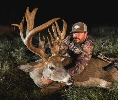 Evan Proctor poses with 218-inch whitetail buck.