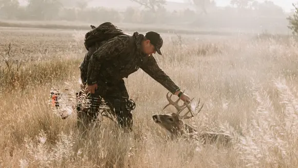 photo of hunter with whitetail buck