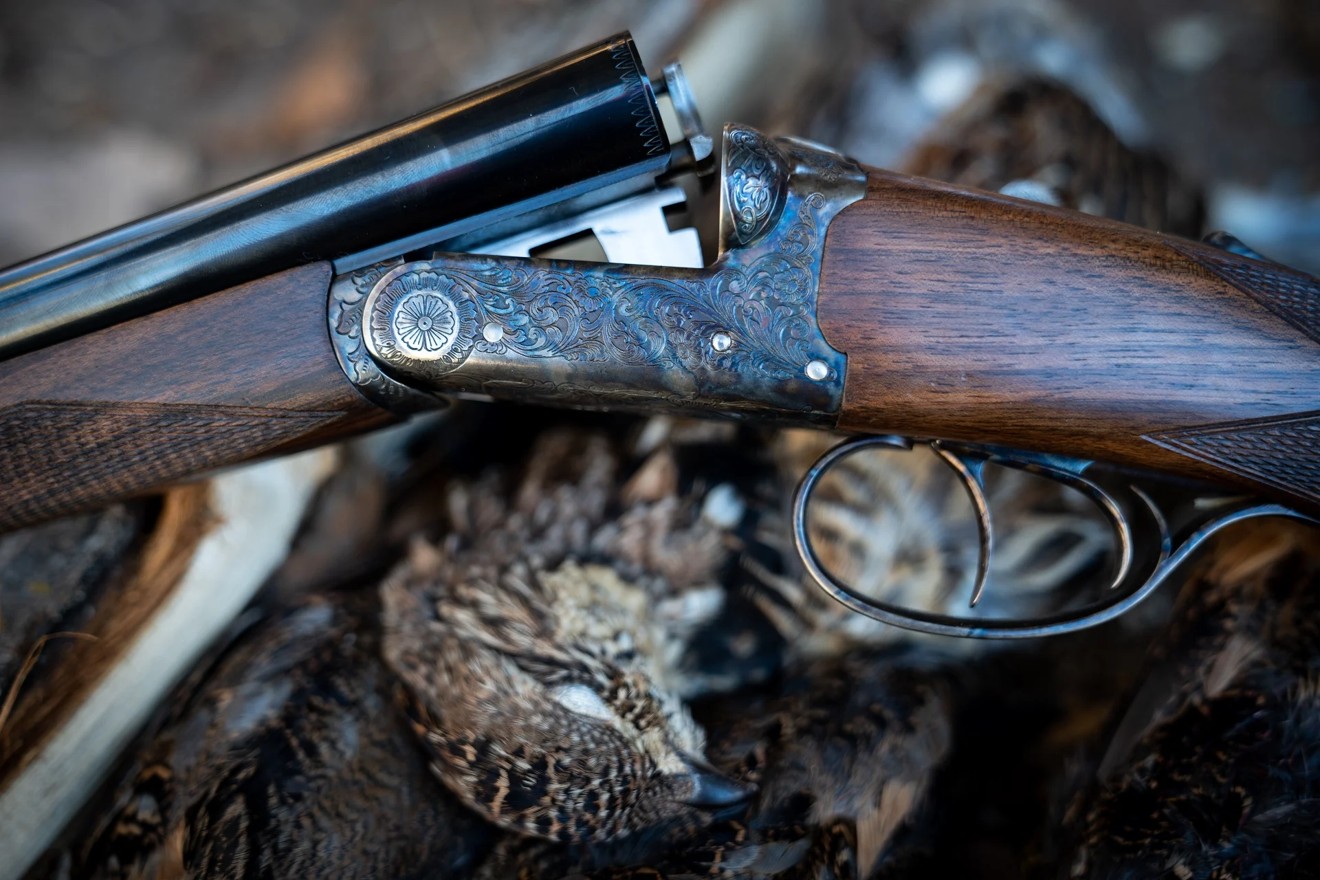 An Upland Gun Company Zeus side-by-side shotgun with ruffed grouse. 