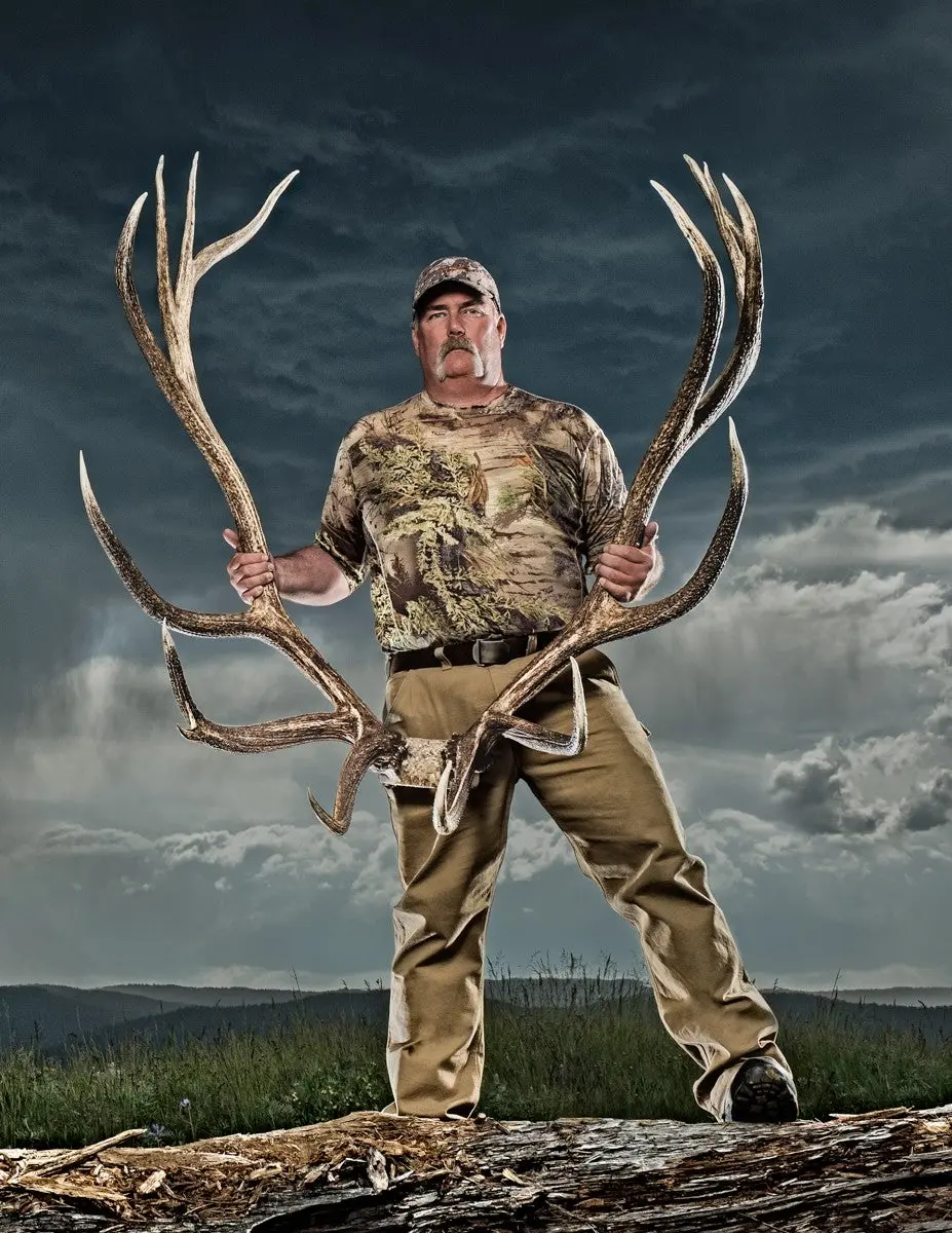 A hunter poses with a world-record bull elk skull. 