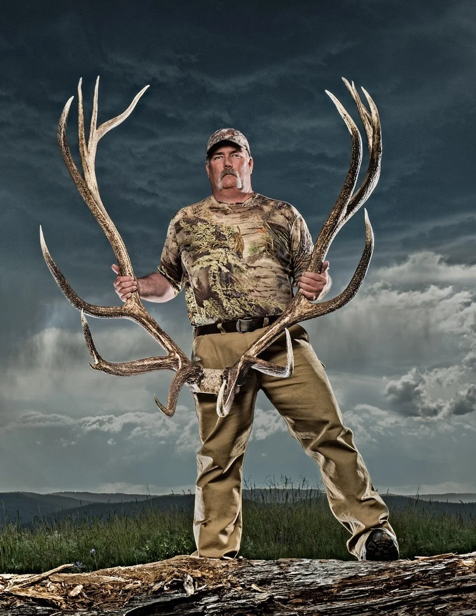 A hunter poses with a world-record bull elk skull. 