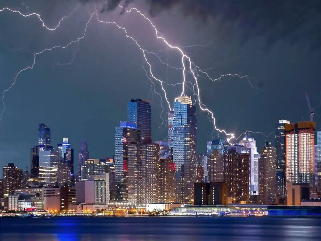 a landscape of the city with a lightning storm