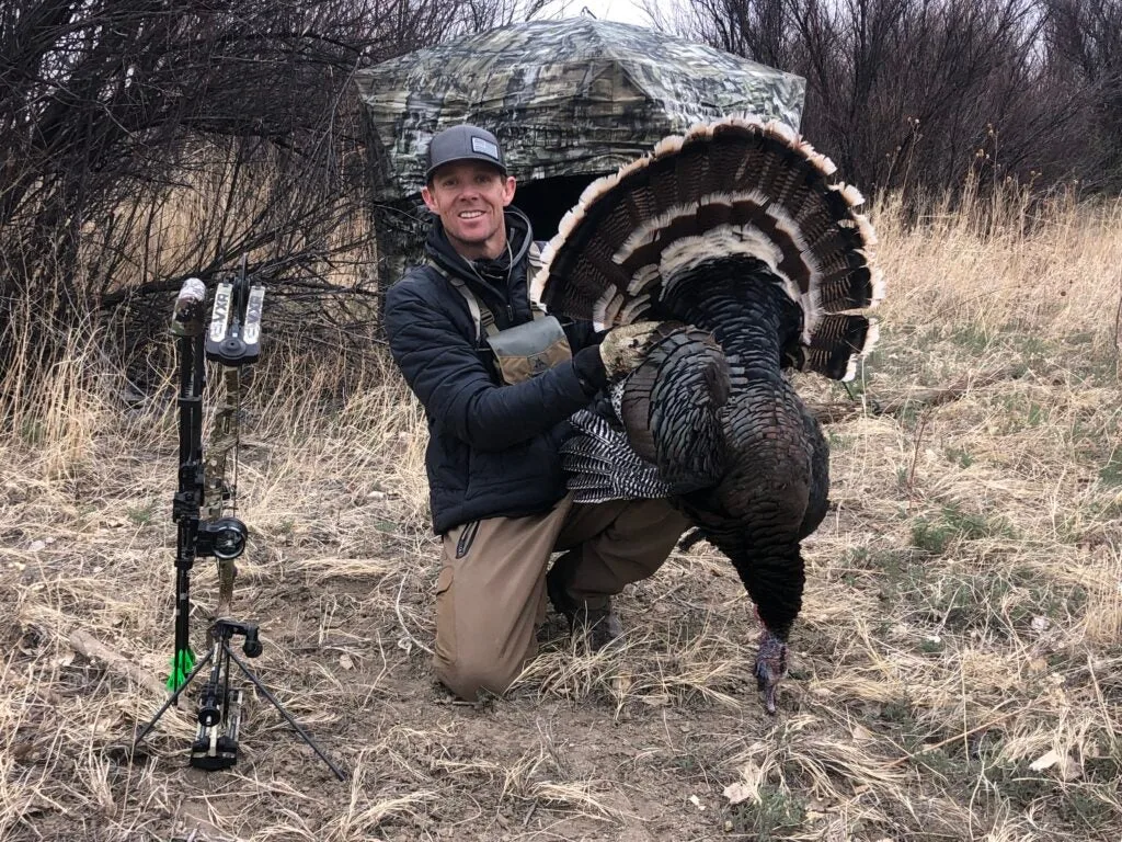 photo of hunter with wild turkey