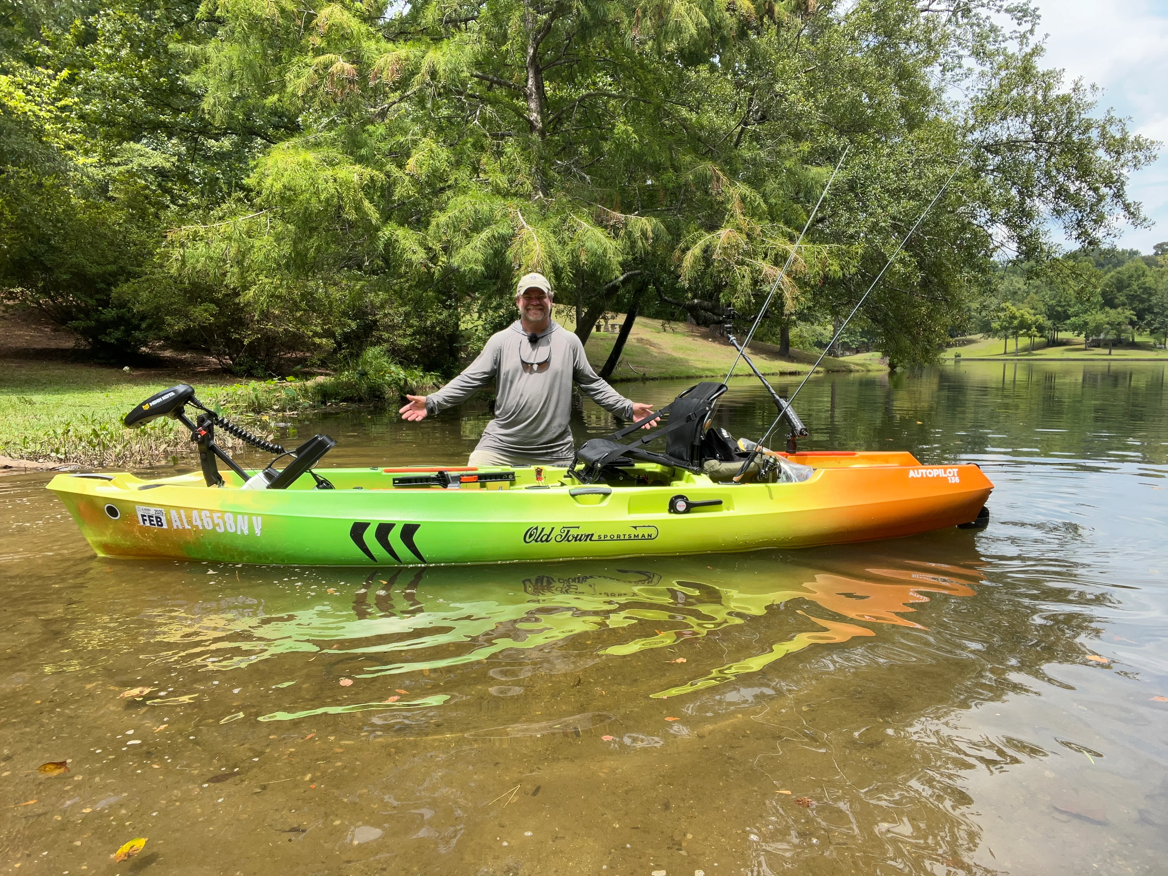 Shaye baker standing next to his old town kayak