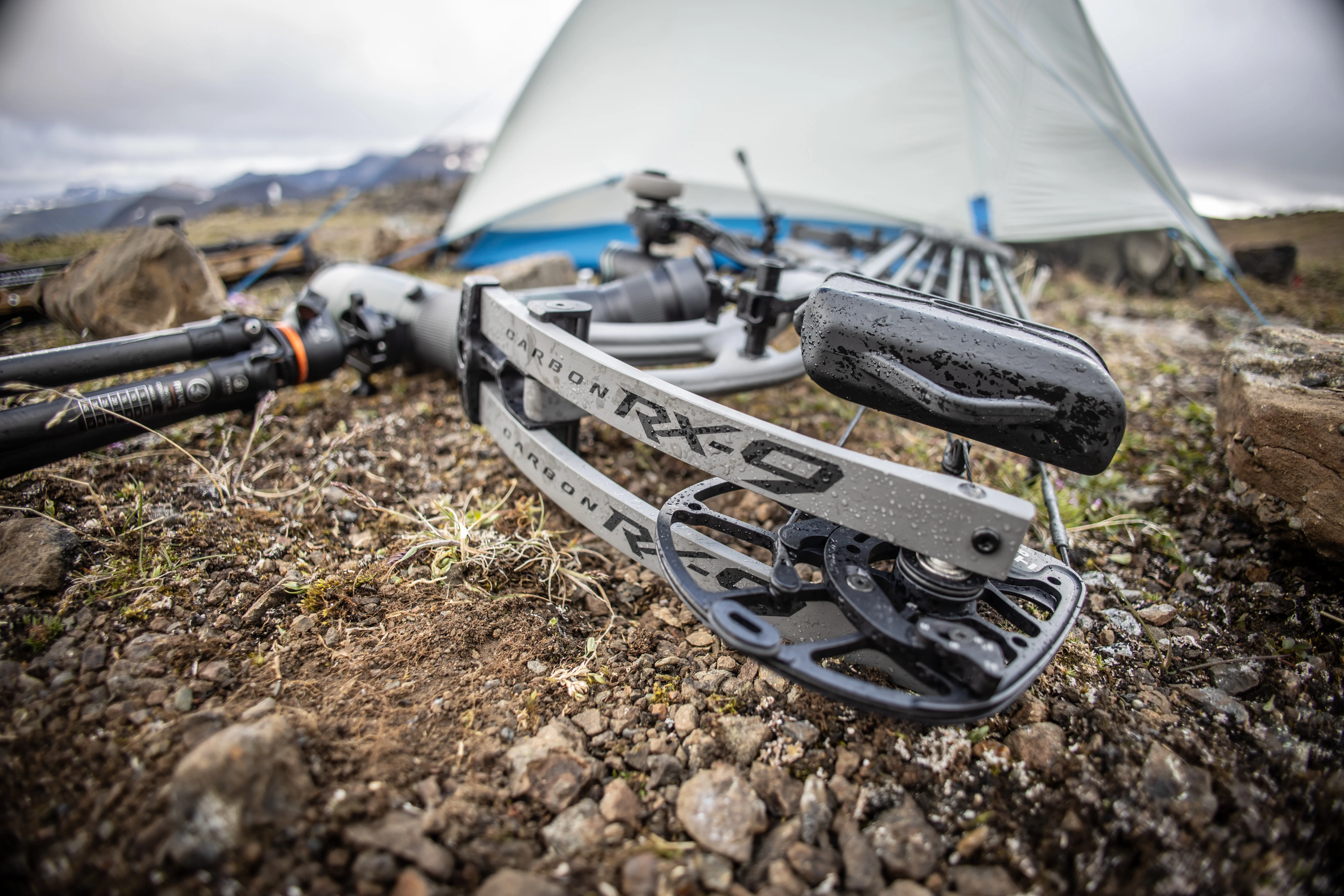 The new Hoyt Carbon RX-9 compound bow resting on the ground near a tent.