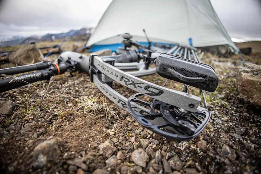 The new Hoyt Carbon RX-9 compound bow resting on the ground near a tent.