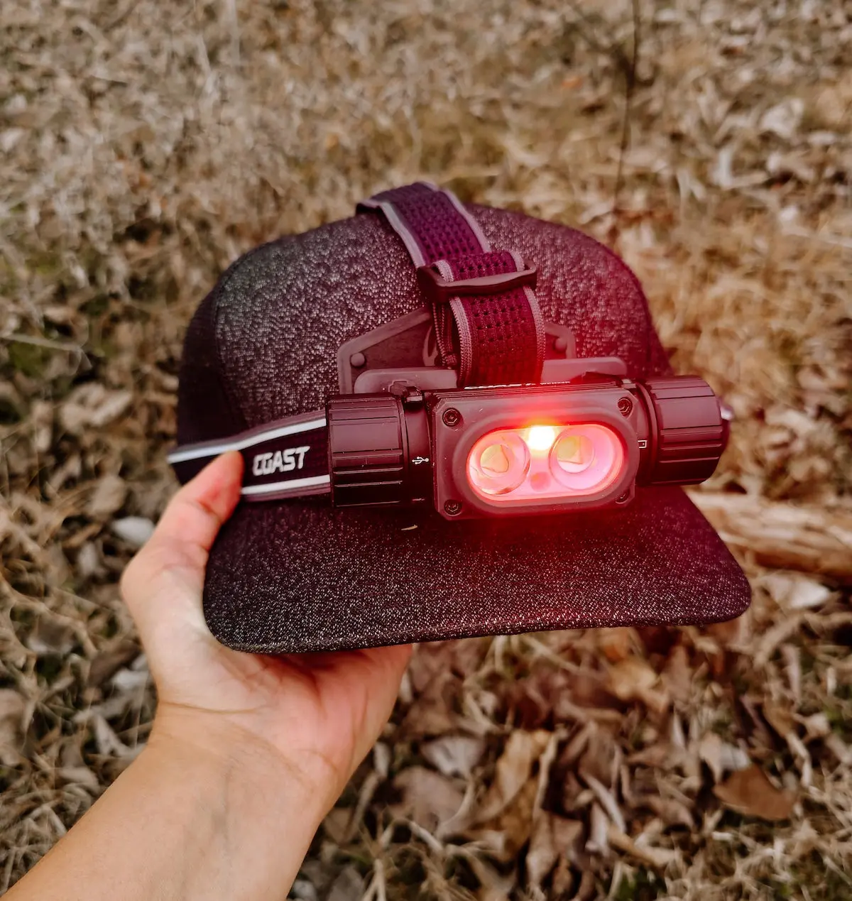 Coast WPH34R Headlamp with red light on hat