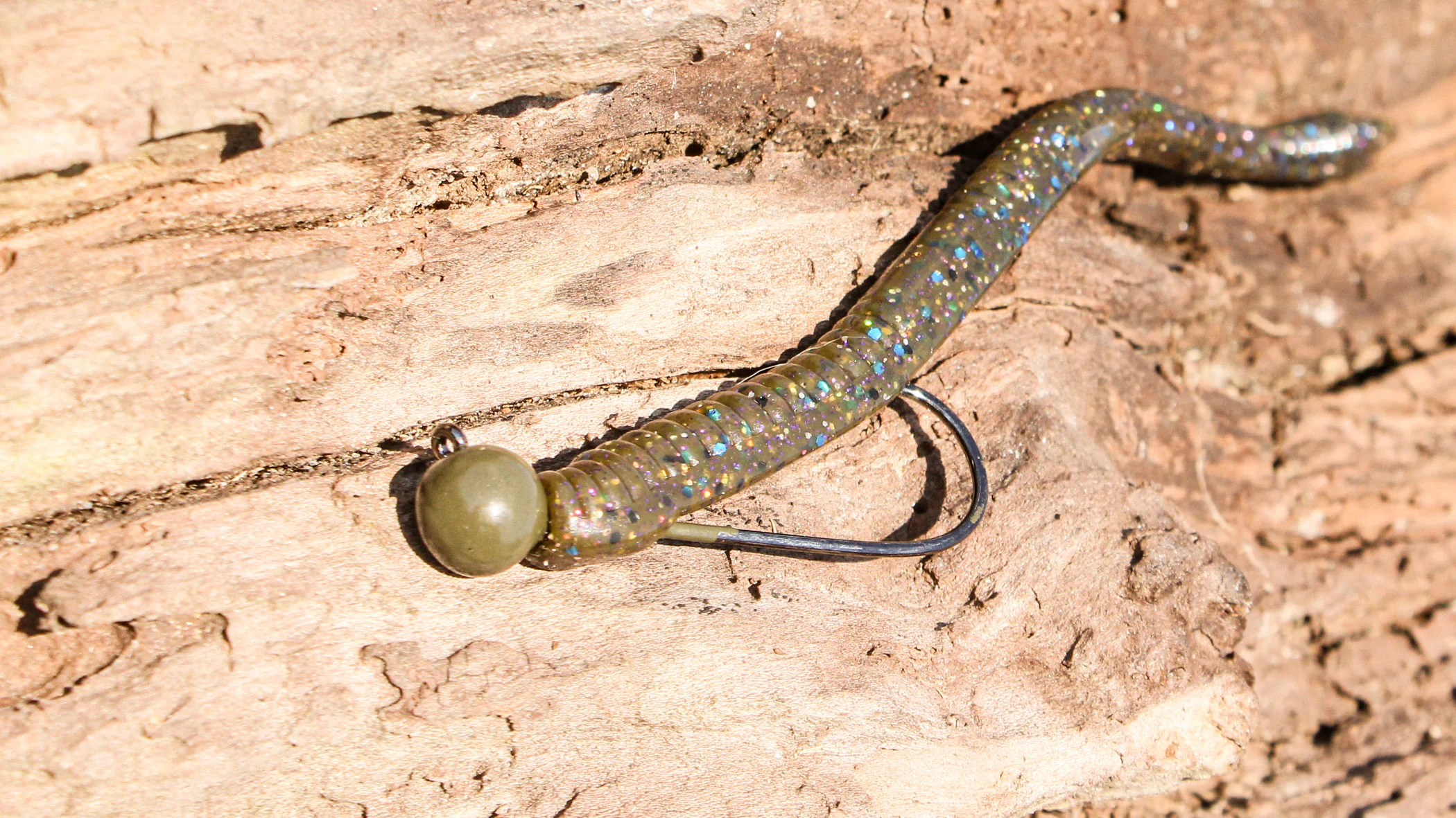 A shaky head bait, show here on a piece of driftwood, is one of the best bass baits for bed fishing. 