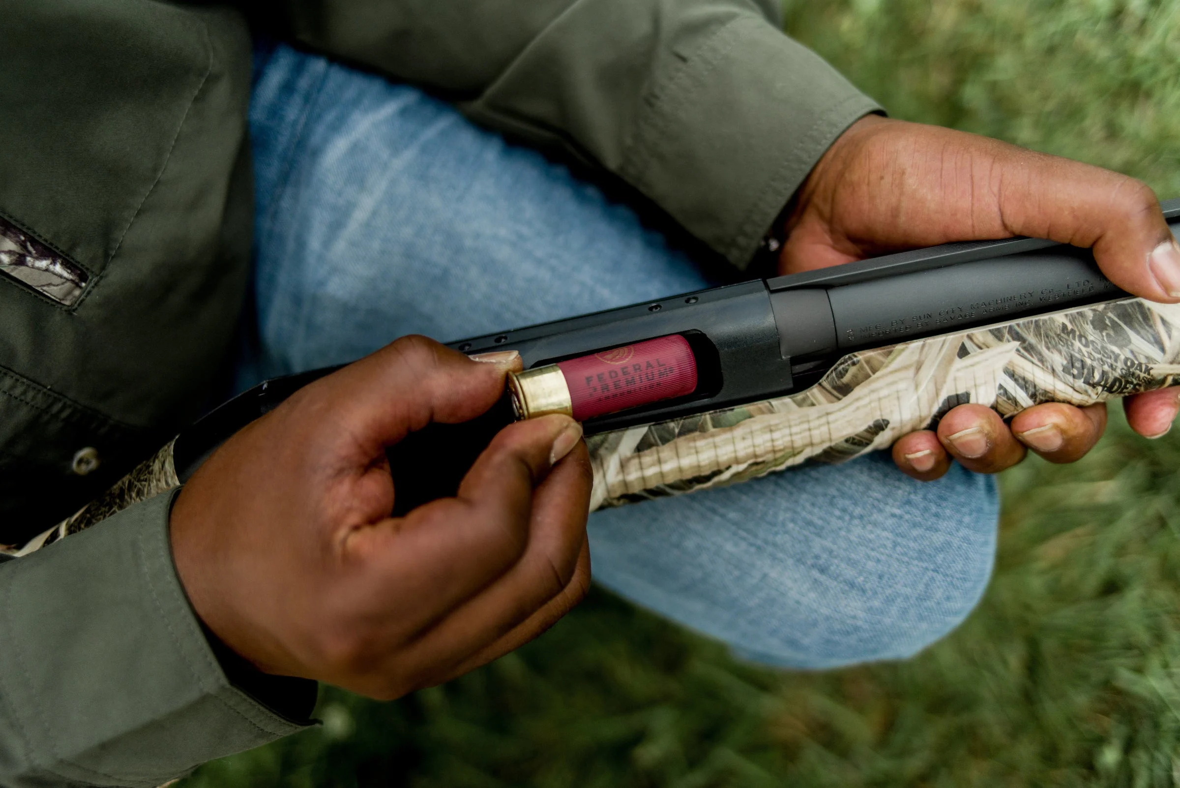 Hunter loads a shotgun.