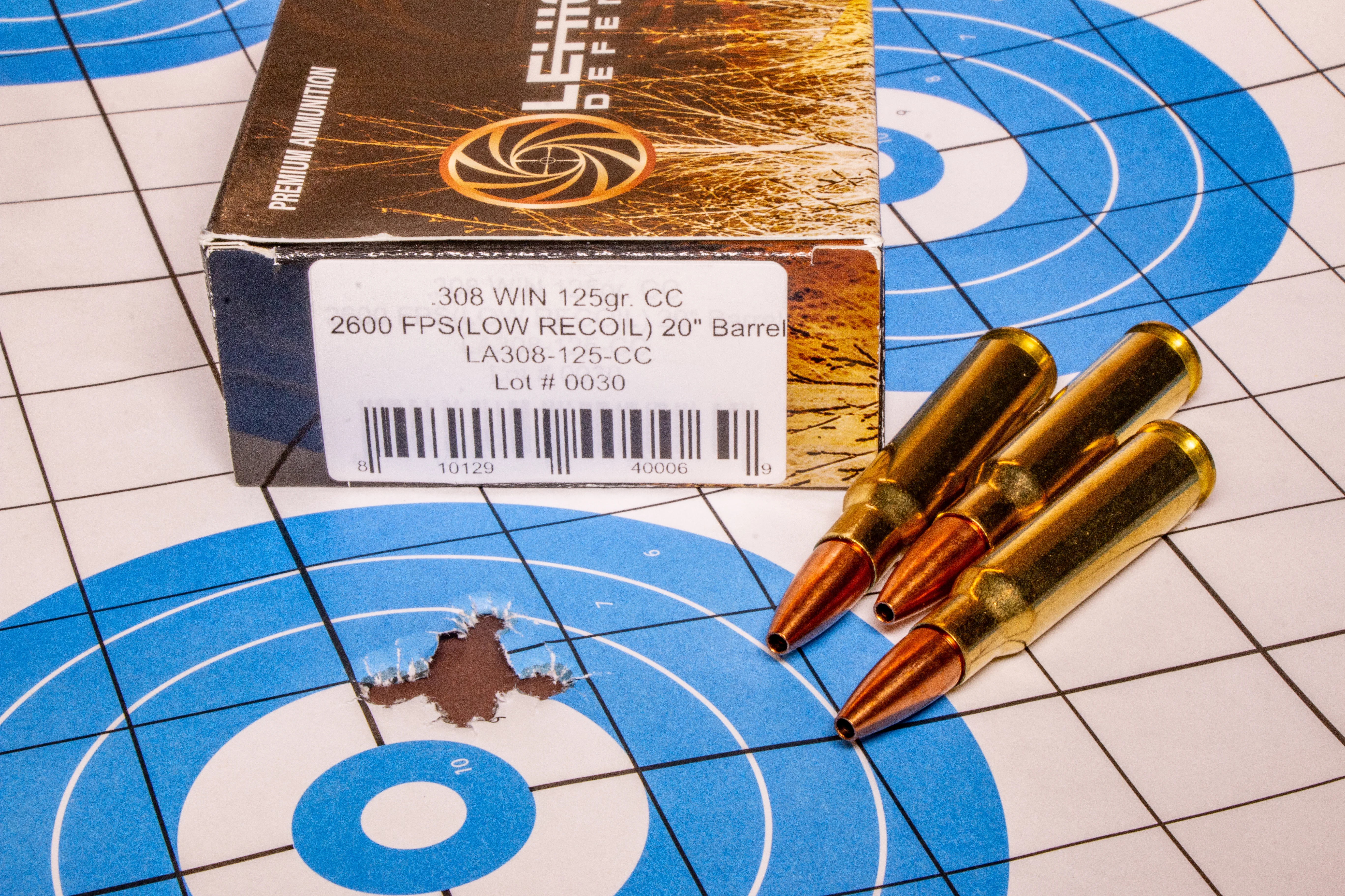 A group shot from the Glenfield Model A rifle on a paper target with ammo nearby. 