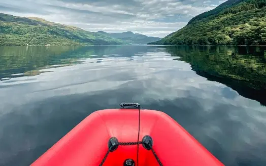 An inflatable boat on a scenic river.