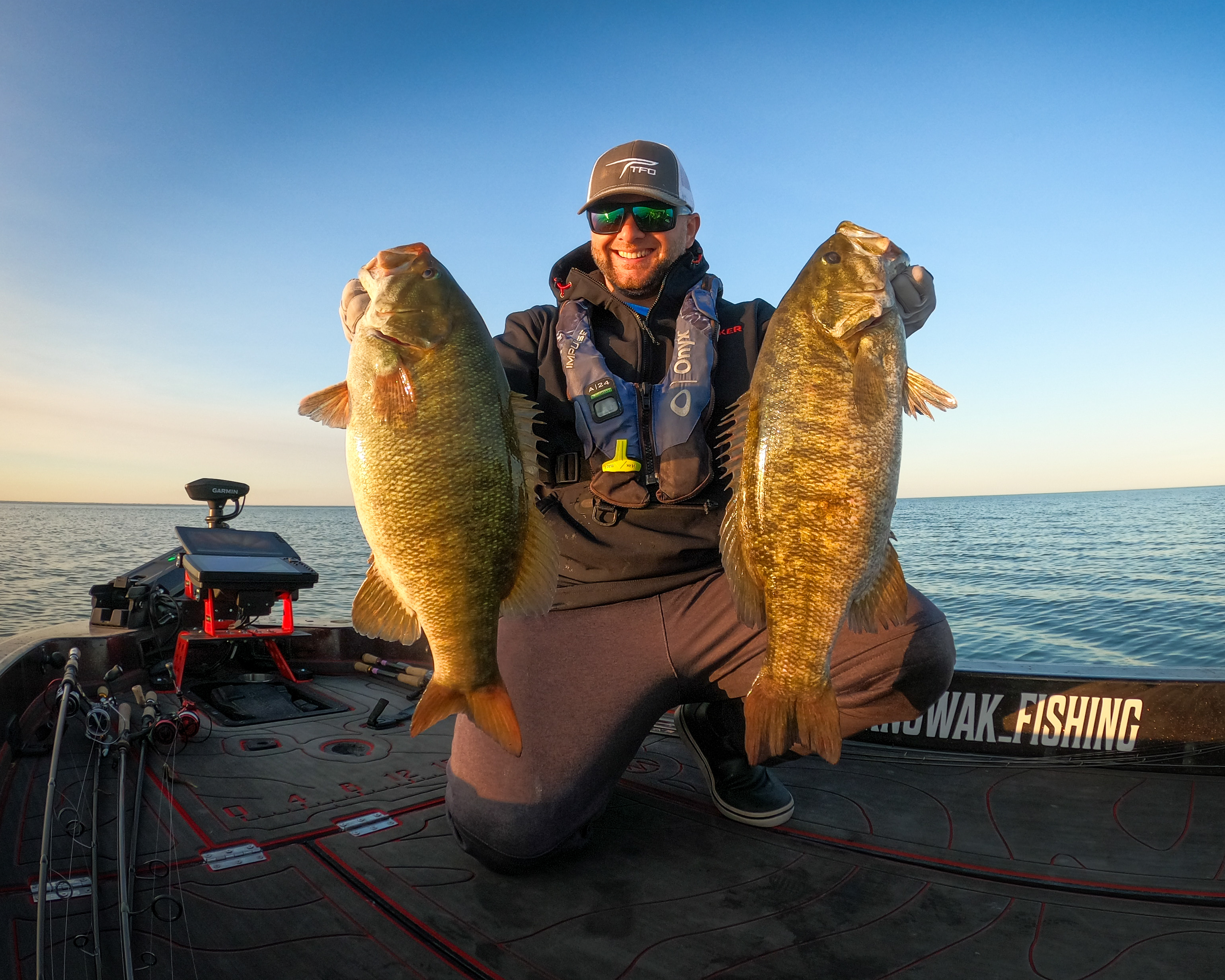 Angler holding up smallmouth bass