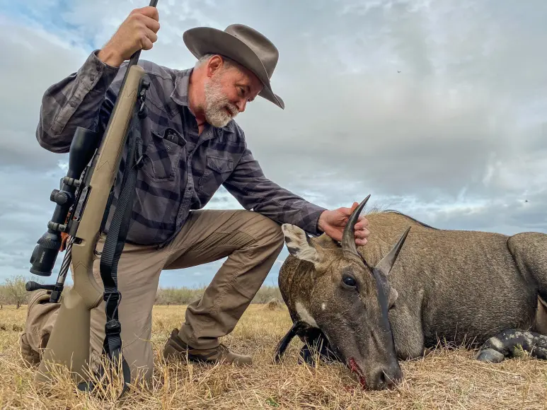 Hunter with a nilgai and the Mossberg Patriot Predator rifle in 7mm PRC.